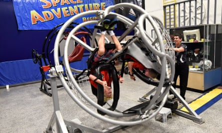 Addison Logan, 10, spins upside down on the Multi-Axis Trainer.