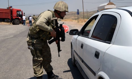 A Turkish soldier checks cars at a checkpoint in Diyarbakir after the car bombing.