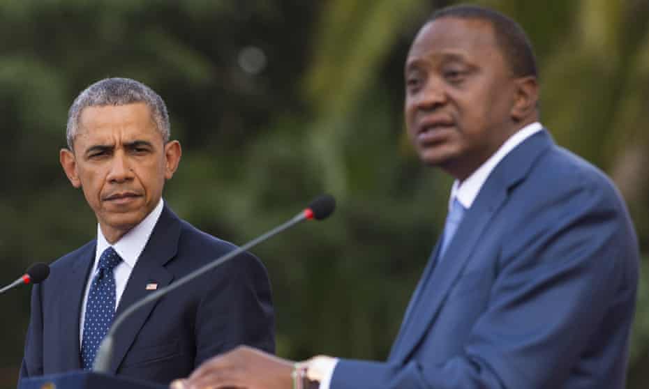 Barack Obama listens to his Kenyan counterpart, Uhuru Kenyatta, during a joint press conference.