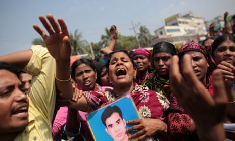 Relatives of victims killed in the collapse of Rana Plaza mourn on the first year anniversary of the accident