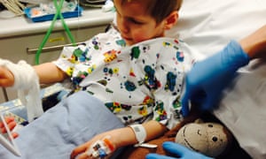 A child being prepared for surgery using an iPad