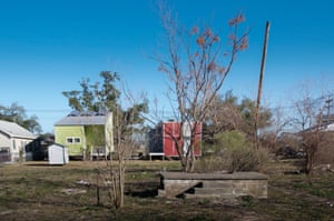 Steps remaining from a destroyed house near colourful modern homes designed with solar panels