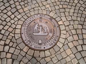 <strong>Stavanger, Norway<br></strong>A decorative sewer lid on a cobbled street