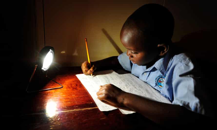 Boy doing homework with use of solar light