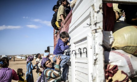 Kurdish refugees get on a bus in Turkey having fled the civil war in Syria.