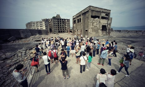 Tourists visit a part of Hashima Island, commonly known as Gunkanjima, which means battleship island, off Nagasaki prefecture, southern Japan.
