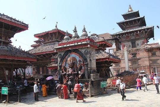 People walk around Durbar Square in Kathmandu on 18 June 2015, with rubble still visible following the April earthquake.