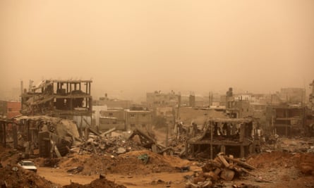 A sandstorm over ruined buildings in Gaza.