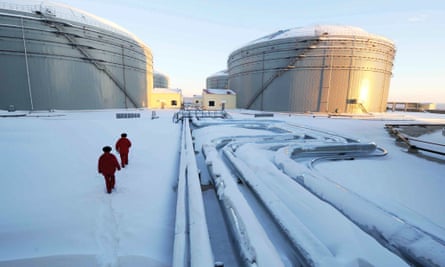 Workers inspect the pipelines and oil storage tanks of a crude oil pipeline between Russia and China in Heilongjiang province, north-east China.