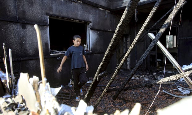 A Palestinian boy inspects a house that was badly damaged in the attack.