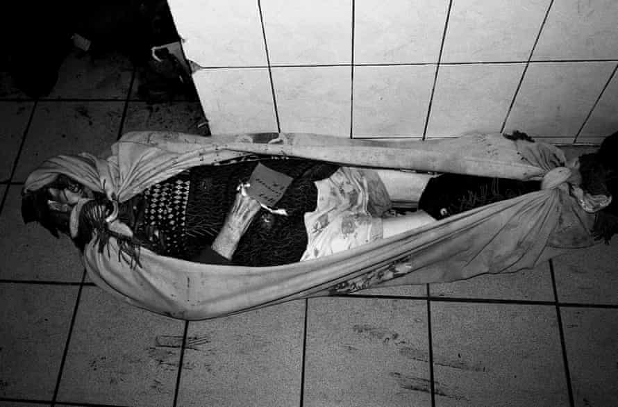 Poldava, 2012: The body of a woman lies on the floor of an overcrowded morgue.