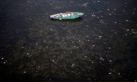 A fishing boat lies anchored in polluted water on the Nile river in Cairo, 2014