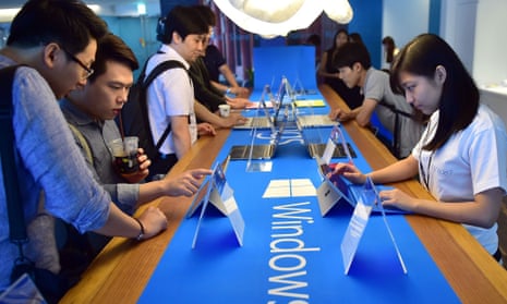 Visitors try out Windows 10, the latest operating system from US software giant Microsoft, during a launch event in Seoul on July 29, 2015. 