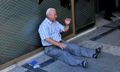 Giorgos Chatzifotiadis, sitting on the ground crying outside a national bank branch in Thessaloniki.