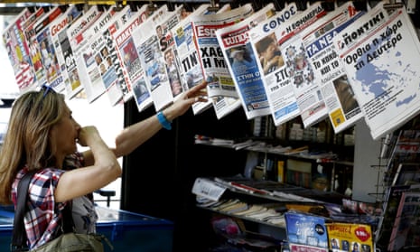 The newspaper on the right showing a map of Greece reads "The country stands up on Monday".