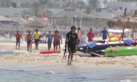 Gunman Seifeddine Rezgui walks along the shore in Sousse, Tunisia. Behind him local men form a chain to stop him from progressing along the beach. The group includes Ibrahim Elghoul with his arm out and Mohammed Dabbou in the yellow shirt third from the left.