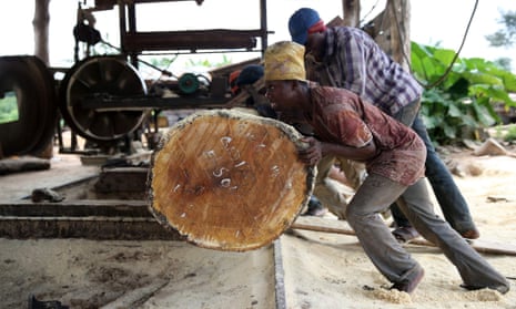 Driving up tax revenues could unleash countries’ full potential … labourers roll a log into a milling machine at a sawmill near Igede-Ekiti township, south-west Nigeria.