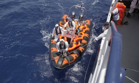 The Migrant Offshore Aid Station's ship, the Phoenix, receives migrants rescued during an attempt to cross the Mediterranean sea.