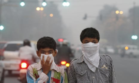 Children cover their face to take precaution from the air pollution in New Delhi. India, alongside Brazil, is among major economies yet to make carbon emissions pledges.
