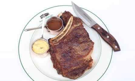 Smith & Wollensky's bone-in ribeye steak next to sauces in pots and a knife