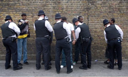 Justice? ... Police stop and search young black men at Notting Hill Carnival.