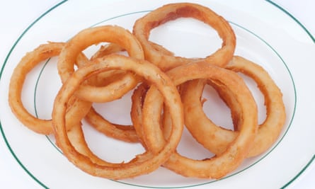10 battered onion rings overlapping on a plate