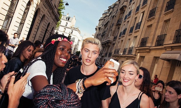 'They just want a photo and a hug': Lucky Blue Smith meets his fans on the streets of Paris, accompanied by his sister Daisy Clementine (on right).