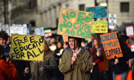 Students hold signs as they march in London against university fees.