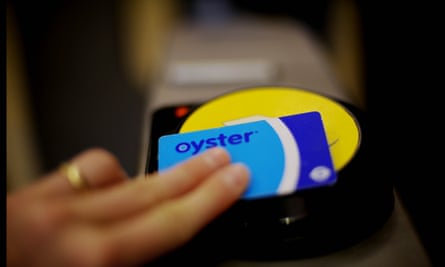 A passenger swipes an Oyster card to validate a journey at an underground station in London. 
