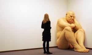 A woman contemplates the sculpture 