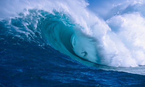 Surfer shooting the curl of Jaws at Peahi on Maui