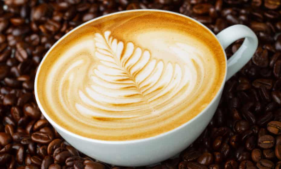 Cup of coffee with a fancy pattern in the foam