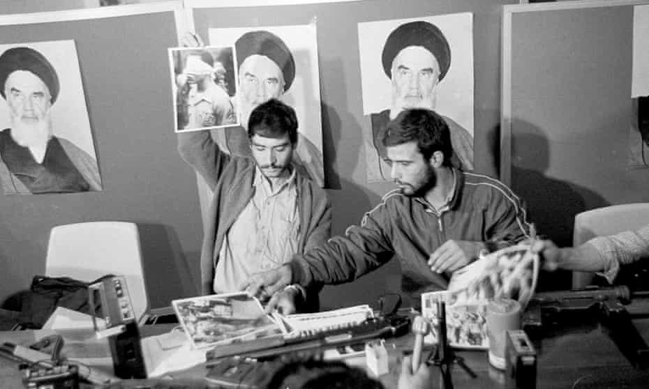 A representative of the Iranian students holds up a portrait of one of the blindfolded hostages, during a press conference in the U.S. Embassy in Tehran, Nov. 5, 1979. 