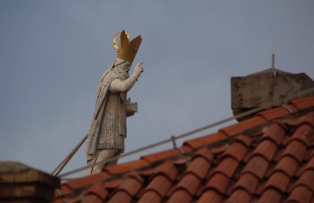 Roof walker. You are only likely to be able to do this with a telephoto lens but the compression of the roof in the foreground with the statue gives the impression that the saintly figure is actually walking on the roof. A bit of fun.