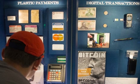 A visitor looks at a display featuring Bitcoin and the Bitcoin exchange rate since 2014, at the National Museum of American History.