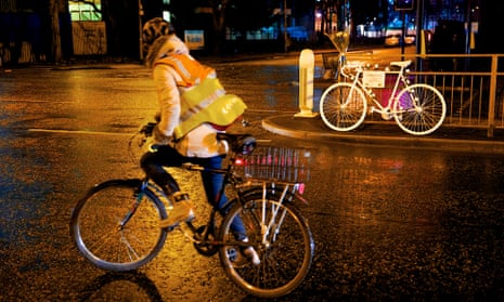 A cyclist passes a ghost bike in Manchester, commemorating cyclist Artur Piotr Ruszel, who was killed in January after colliding with a car on Upper Brook Street in the city.