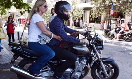 Varoufakis leaves on his motorcycle with his wife Danae Stratou after resigning on 6 July 2015