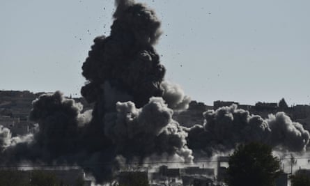 Smoke rises after an airstrike on the city of Kobane in Syria