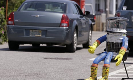 A car drives by Hitchbot  in Marblehead, Massachusetts, in July.