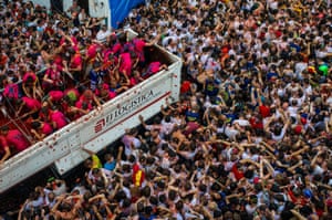 Revellers enjoy the atmosphere in tomato pulp while participating the annual Tomatina festival on August 26, 2015 in Bunol, Spain. An estimated 22,000 people threw 150 tons of ripe tomatoes in the world's biggest tomato fight held annually in this Spanish Mediterranean town.
