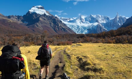 Tourists hiking on a path towards Los Cuernos "the Horns" at Torres del Paine National Park