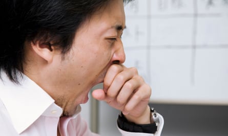 businessman yawning at office