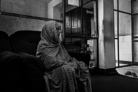 A woman waits outside Arab Shah's office for her appointment.
