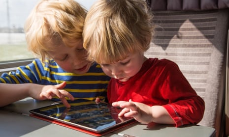 Two children using an iPad