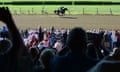 Spectators watch Triple Crown winner American Pharoah work out at Saratoga Race Course. American Pharoah is preparing to run in the Travers Stakes on Saturday.