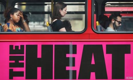 Passengers ride a bus displaying an advert for a movie entitled The Heat on July 17, 2013 in London, England.