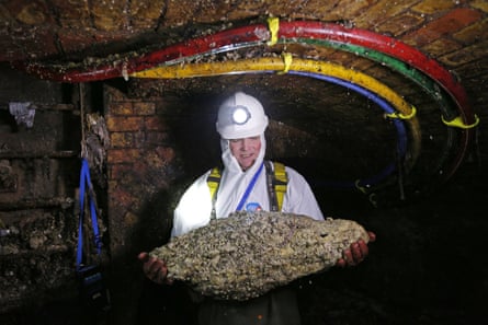 A ‘flusher’, or trunk sewer technician, holds a fatberg.