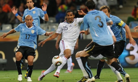 France's midfielder Florent Malouda (centre) Uruguay's Egidio Arevalo (left) and Diego Lugano (right) during their first round match at the 2010 World Cup.