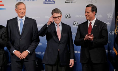 Republican U.S. presidential candidate and former Texas Governor Rick Perry (C) salutes as he poses on stage with fellow candidates former New York Governor George Pataki (L) and former U.S. Senator Rick Santorum