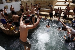 Palestinians and Israelis bathe in a natural spring in Ein Fawwar, near the West Bank city of Jericho. Temperatures in the Jordan valley reached 48 degrees Celsius this week. 
